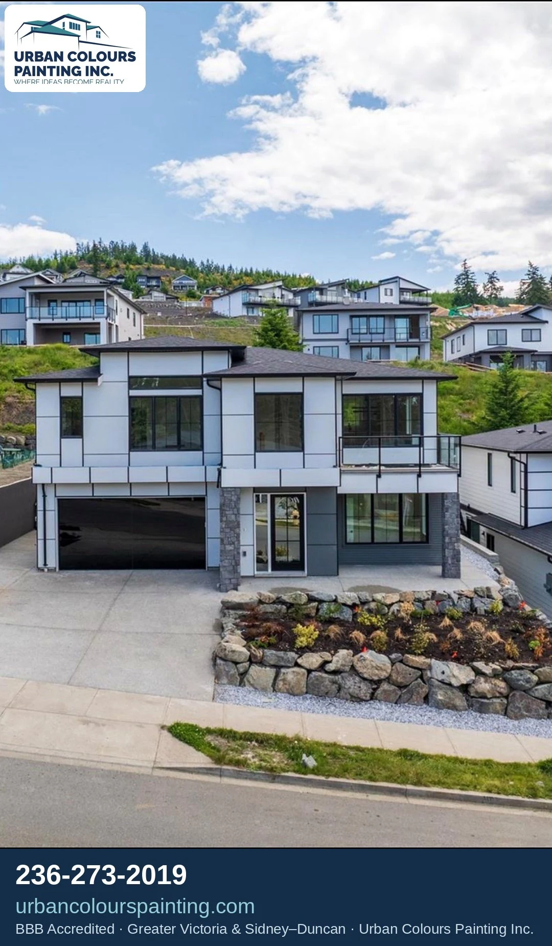 Completed modern home exterior with painted siding, trim and entry details.