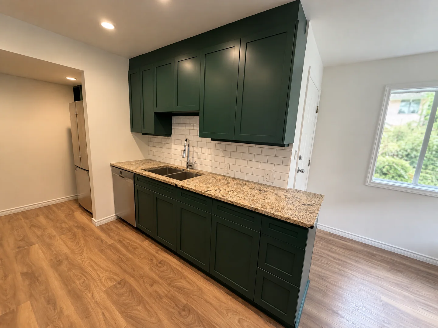 Finished dark green kitchen cabinet faces in a recent residential project